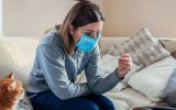 1_ill-woman-checking-thermometer-having-fever-girl-wearing-protective-mask-while-having-cold-flu-at.jpg